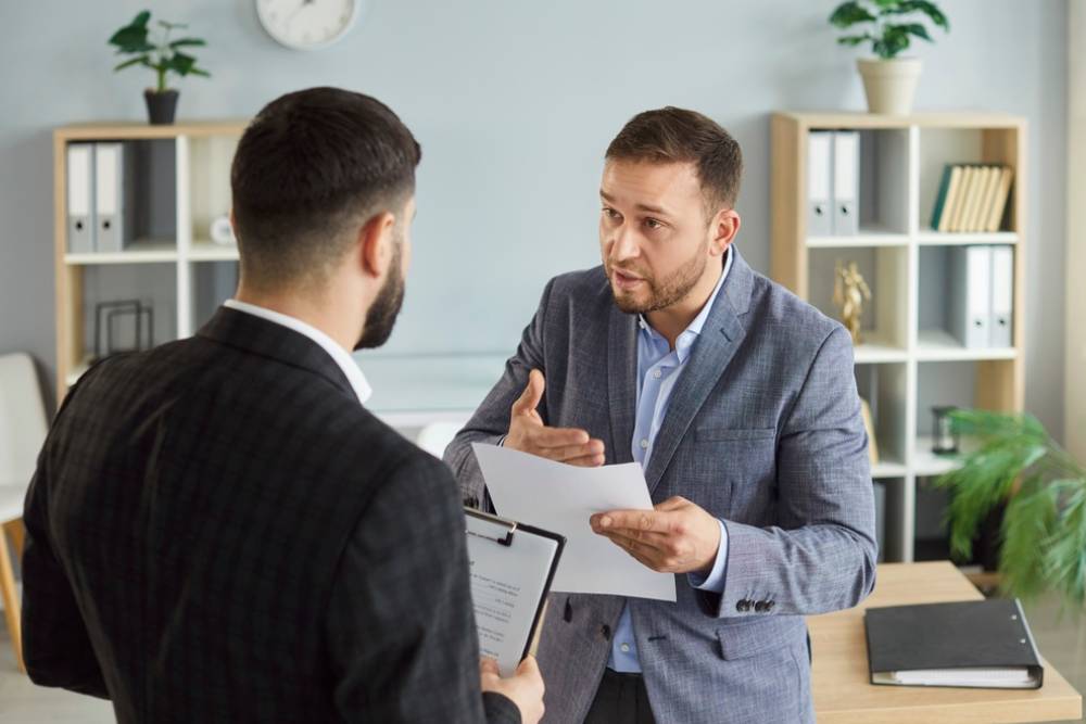 Dissatisfied business people colleagues disputing having disagreement at workplace.
